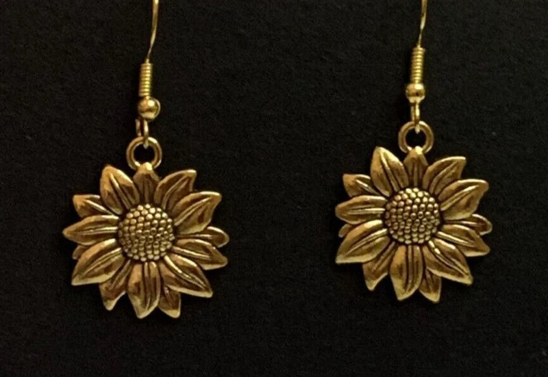 Gold-tone sunflower drop earrings with textured center and detailed petals