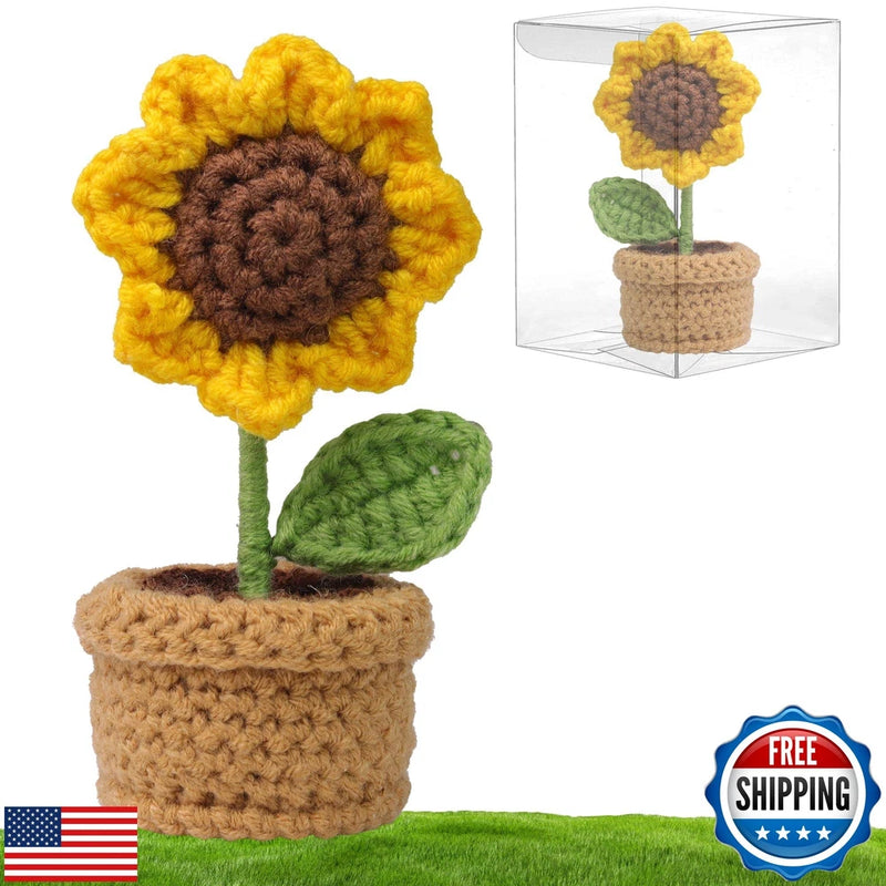 Crochet sunflower decoration with yellow petals, brown center, green leaf, in tan pot
