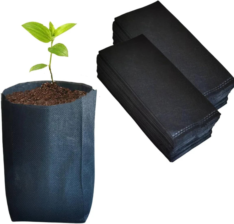 Non-woven plant grow bags, stacked with one bag holding soil and a small seedling