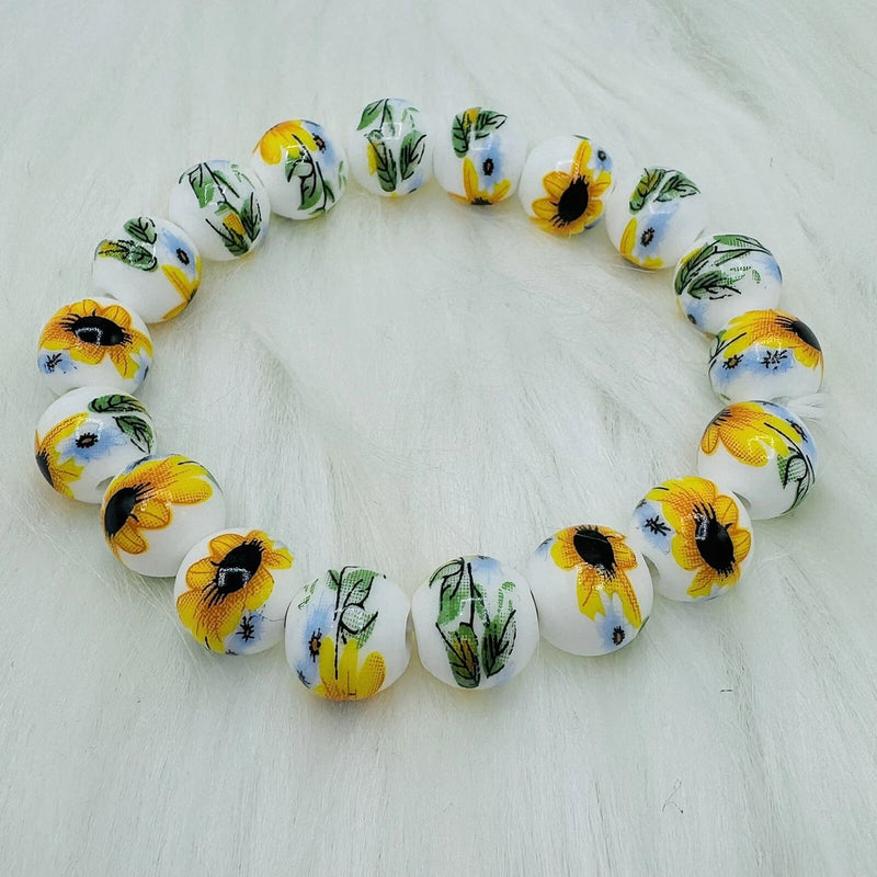 Sunflower beaded ceramic bracelet with white beads and yellow sunflower prints