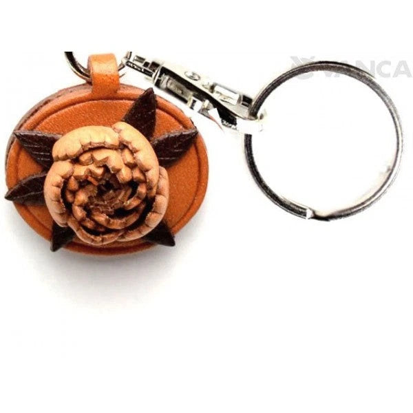 Leather flower keychain with orange and dark brown layered petals and metal keyring