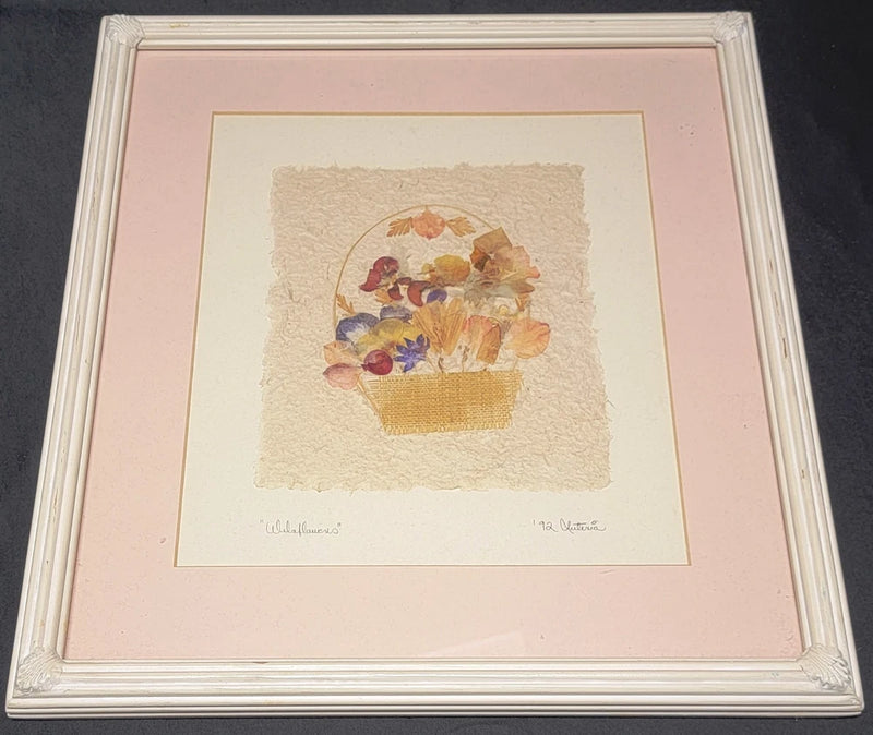 Framed pressed flower artwork with dried bouquet in a small paper box on off-white print