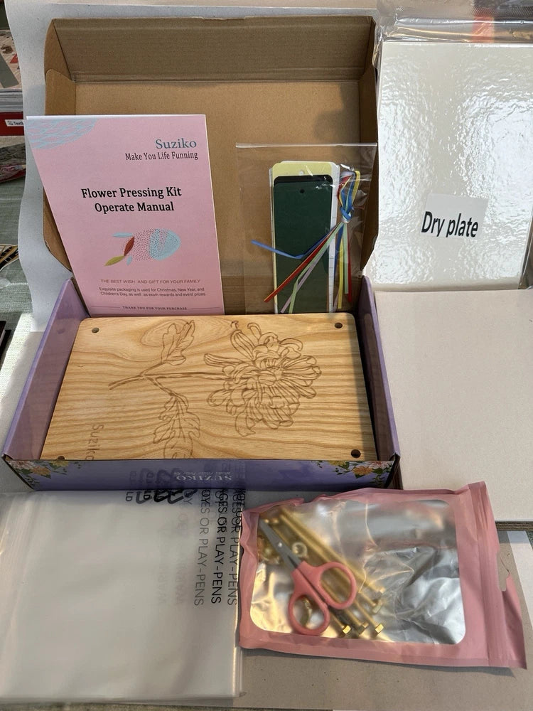 Wooden flower press kit with manual, dry plate, and included tools in packaging
