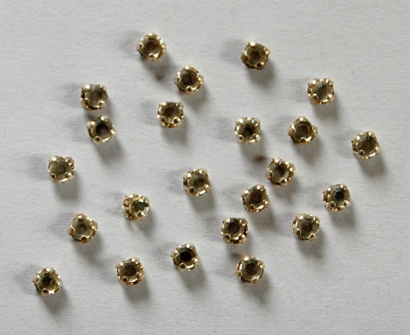 Small round sew-on rhinestones with gold-tone settings, clear crystal centers