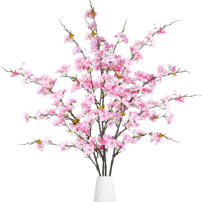 Pink faux cherry blossom stems with clustered flowers, multiple twigs bundle in vase