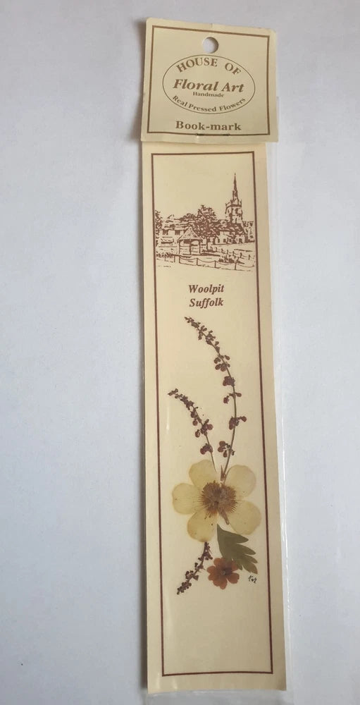 Sealed pressed-flower bookmark with purple sprig and yellow flower, vertical design