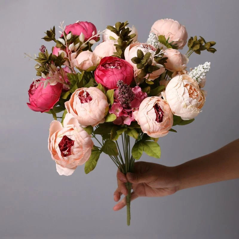 Artificial peony flower buds bouquet with pink and peach blooms and green leaves