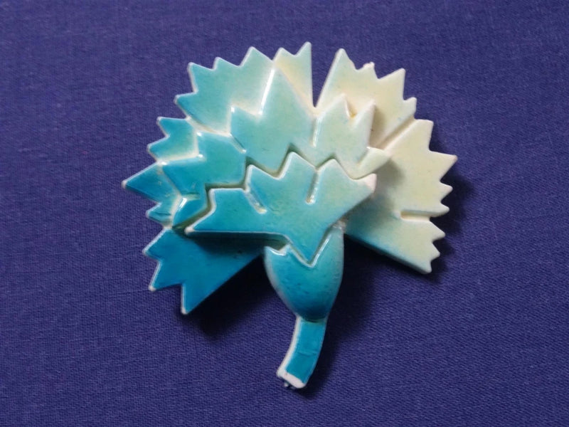 Blue-green carnation flower brooch with enamel-look petals and pin