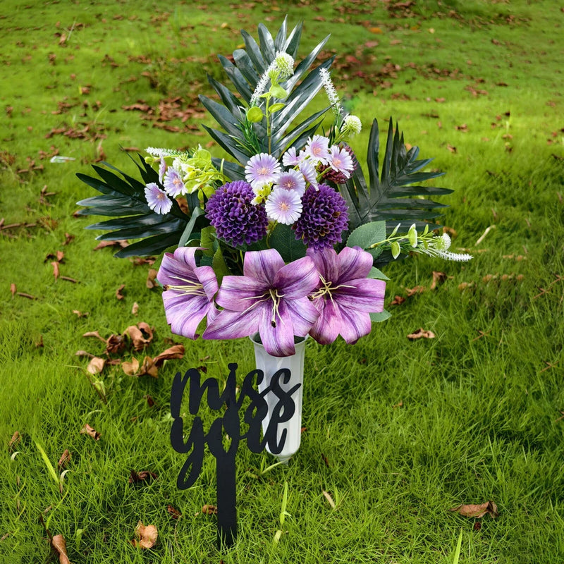 Artificial purple lily flower arrangement in black memorial vase with Miss You text