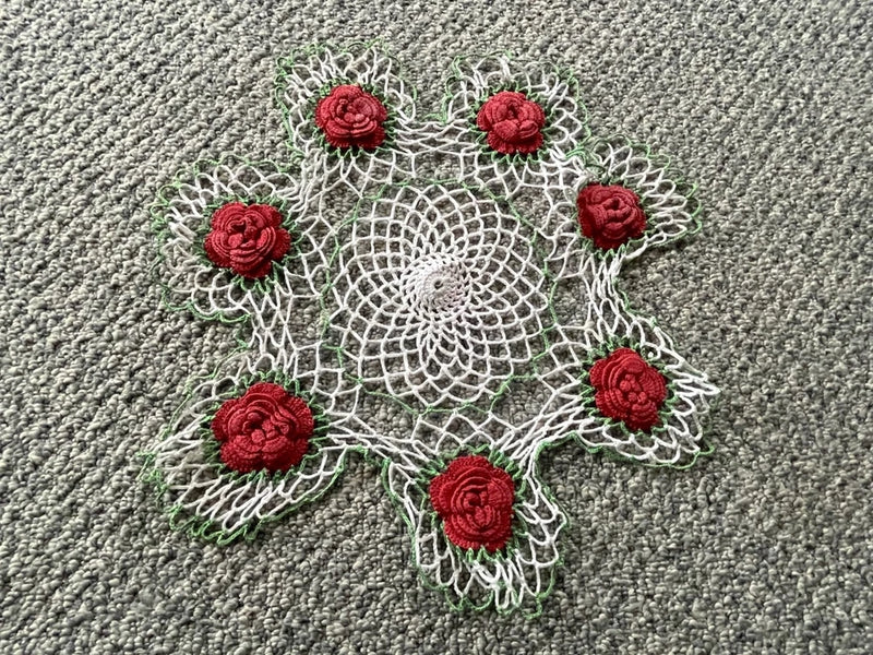 Handmade scalloped doily with raised red roses and white crochet