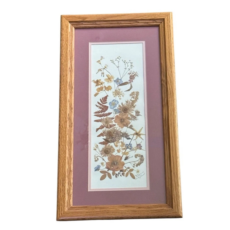 Wood-framed pressed floral art with dried flower bouquet in a light mat