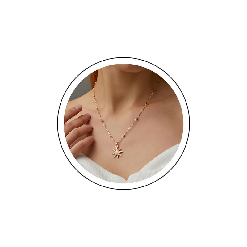 Gold-tone choker necklace with sunflower pendant and small opal-like stones