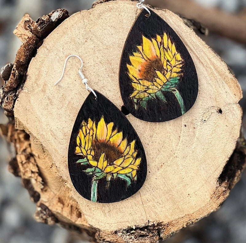 Handmade sunflower dangle earrings with black teardrop canvas and yellow floral design
