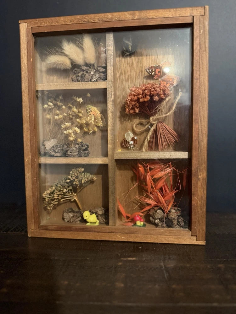 Vintage shadow box with dried flowers and grasses in a wooden frame