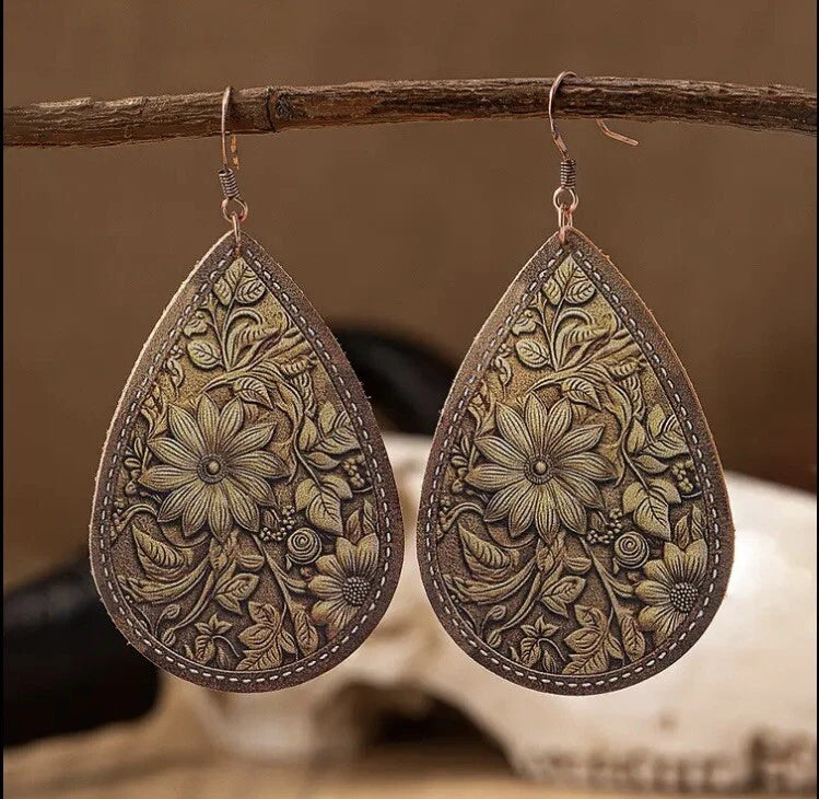 Faux leather teardrop earrings with embossed sunflower floral pattern and silver hooks