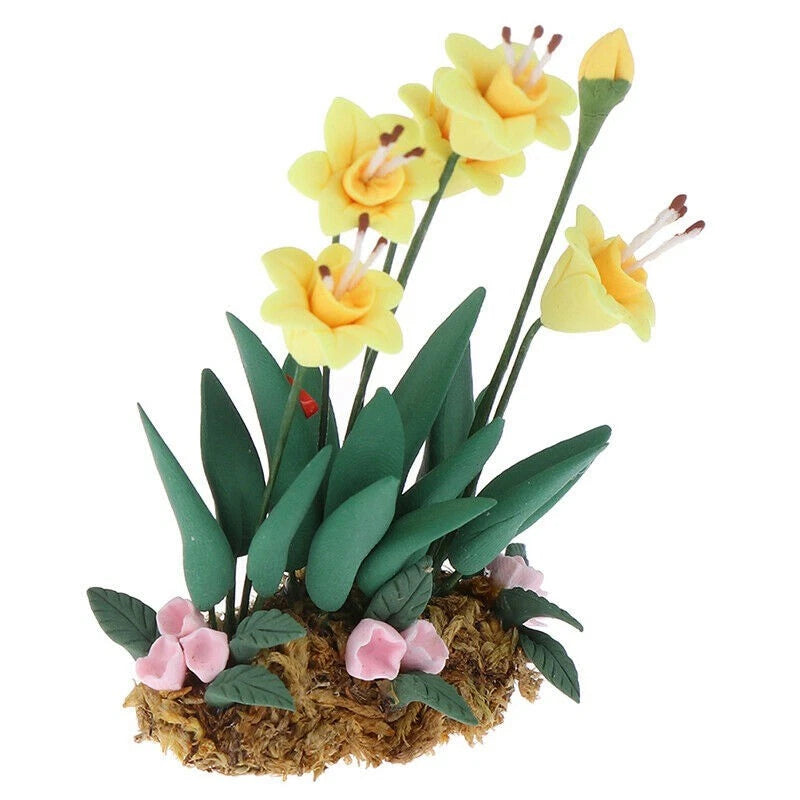 Miniature garden flower plant ornament with yellow blooms, pink accents, and green leaves