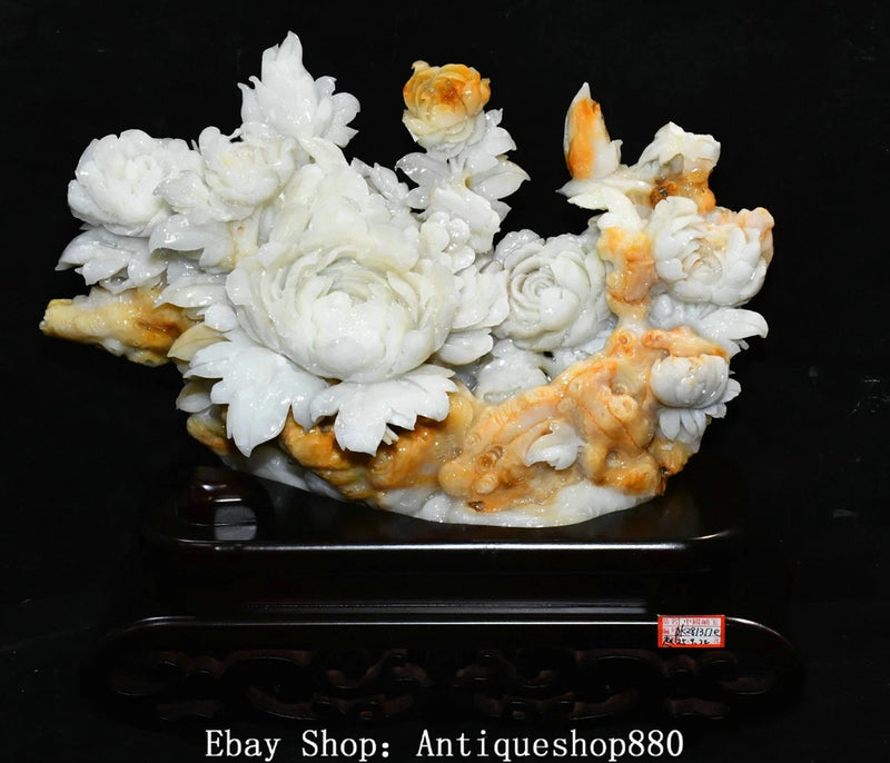 White and orange jade peony flower carving statue on dark ornamental stand
