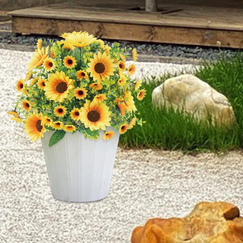Faux sunflower ball bush with yellow blooms and green leaves in white planter pot