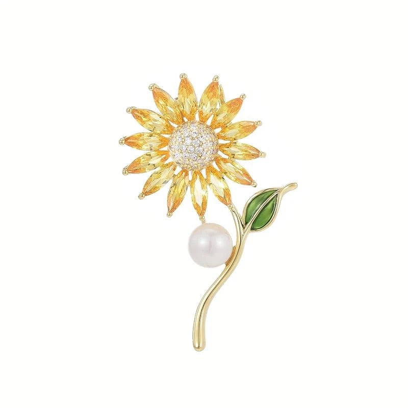 Gold-tone sunflower rhinestone brooch pin with pearl drop and enamel green leaf