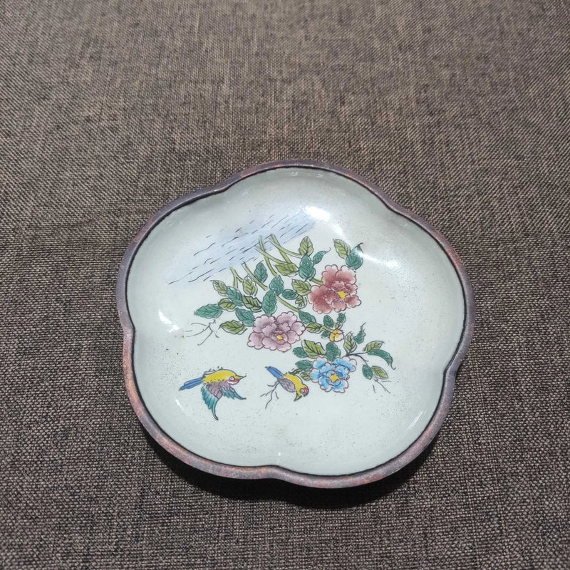 Decorative enamel tea tray with peony flowers and small birds on a light background
