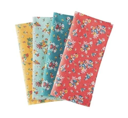 Multicolor floral fabric napkins, three folded squares with small rose prints