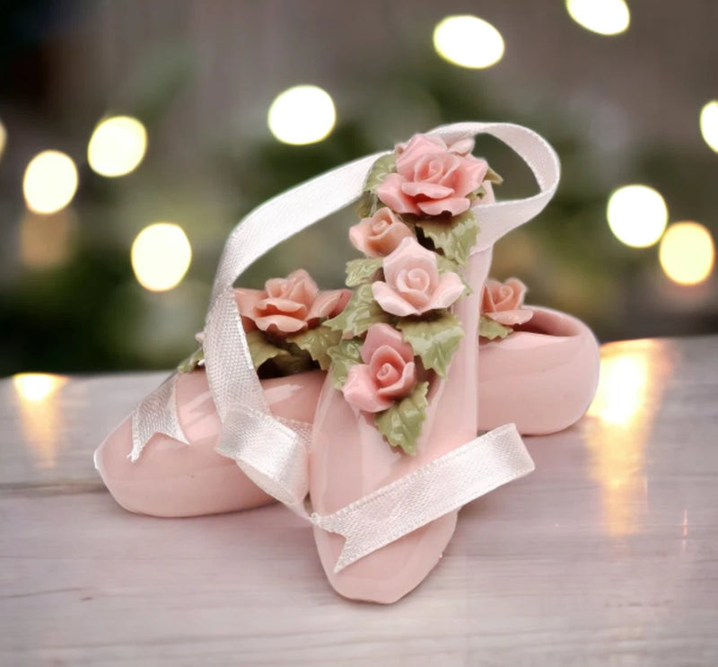 Pink ceramic ballerina pointe shoe figurine with rose flowers and satin ribbon.