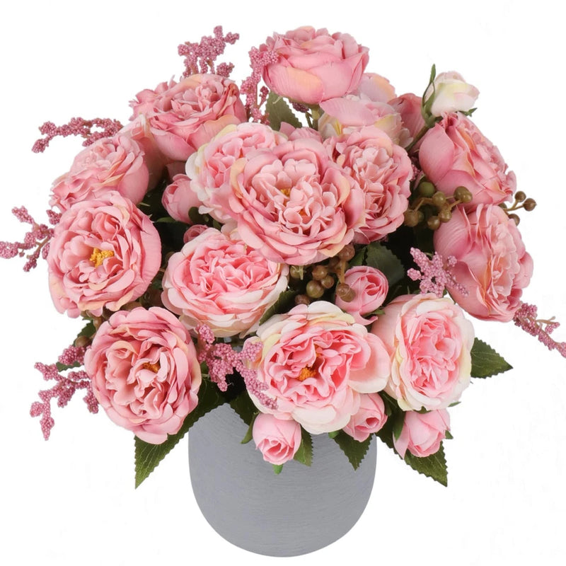 Artificial pink peony bouquet with faux silk blooms and leaves in a gray vase