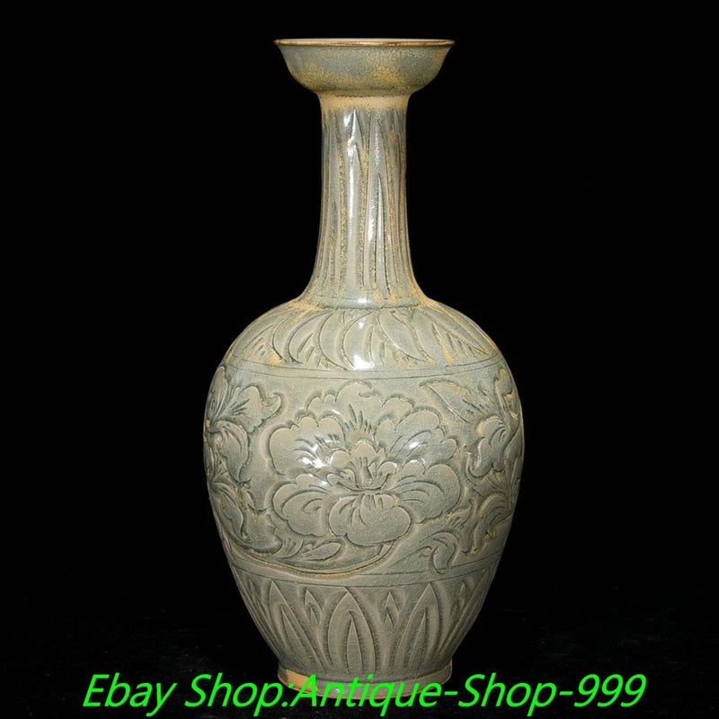 Celadon porcelain bottle vase with carved peony floral relief and tall neck