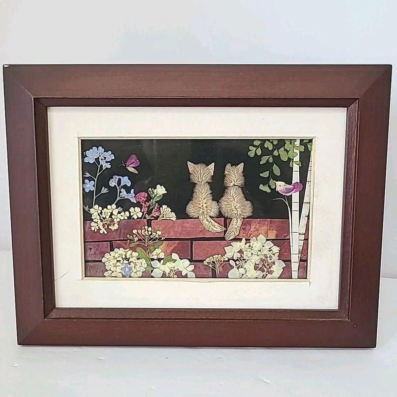 Framed pressed flower and cat wall art with rabbits, butterflies, and green vines inside