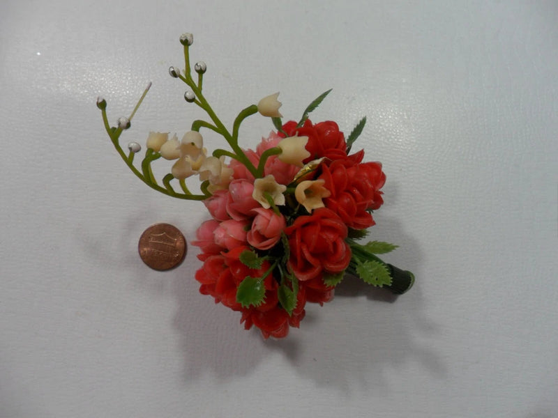 Small plastic rose bouquet with red and cream roses, green leaves, single stem cluster.
