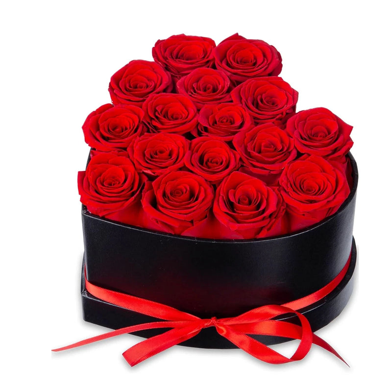 Black gift box filled with red preserved roses and tied with red satin ribbon