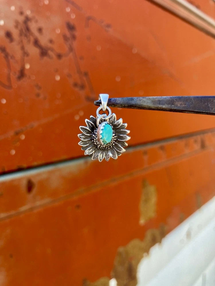 Sterling silver sunflower pendant with turquoise center, detailed petal design