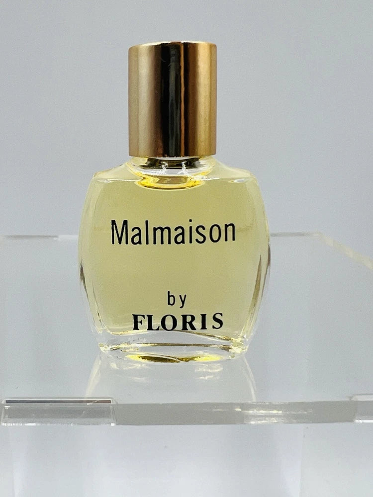 Eau de toilette bottle with gold cap, clear glass; label reads "Malmaison by FLORIS"