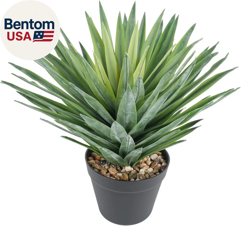 Artificial agave plant in dark pot with green spiky leaves and stone pebbles
