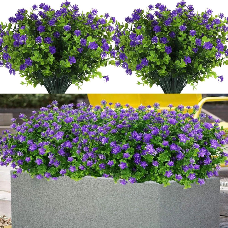 Artificial purple flowering plants bundle with green foliage in gray planter
