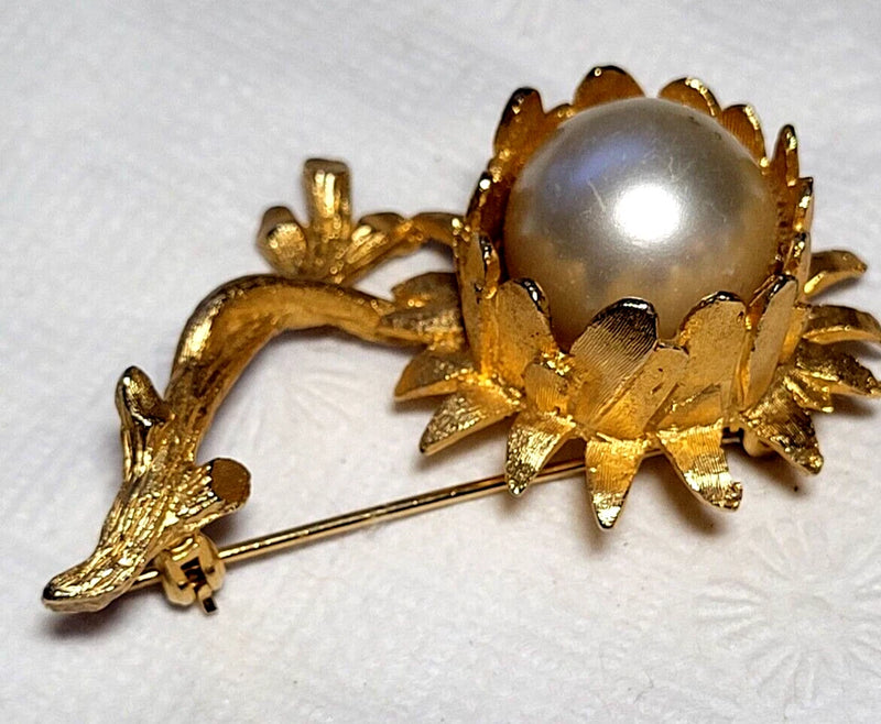 Gold tone textured sunflower brooch with faux pearl center and pin back