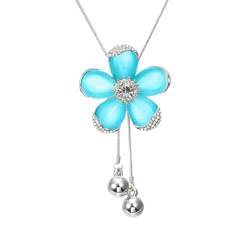 Long necklace with turquoise rhinestone sunflower pendant and two dangling bead charms