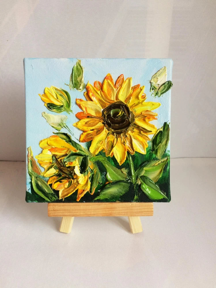Sunflower canvas oil painting with textured 3D flowers on a small wooden easel