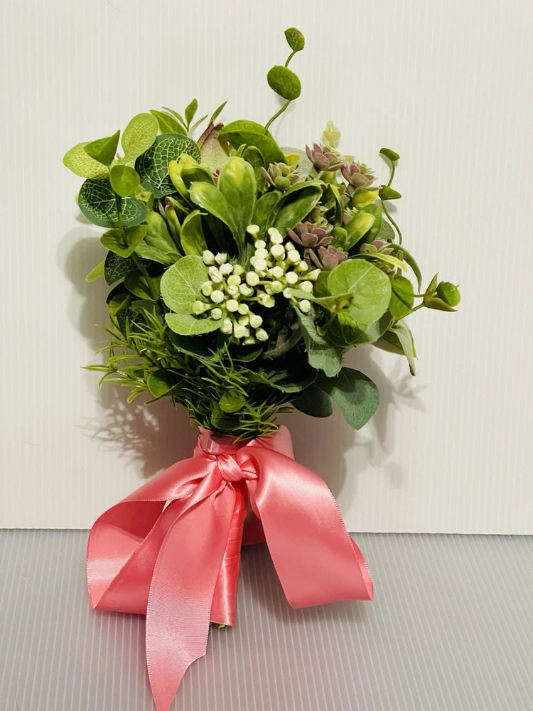 Small bridal bouquet with green succulent foliage and pink satin ribbon bow