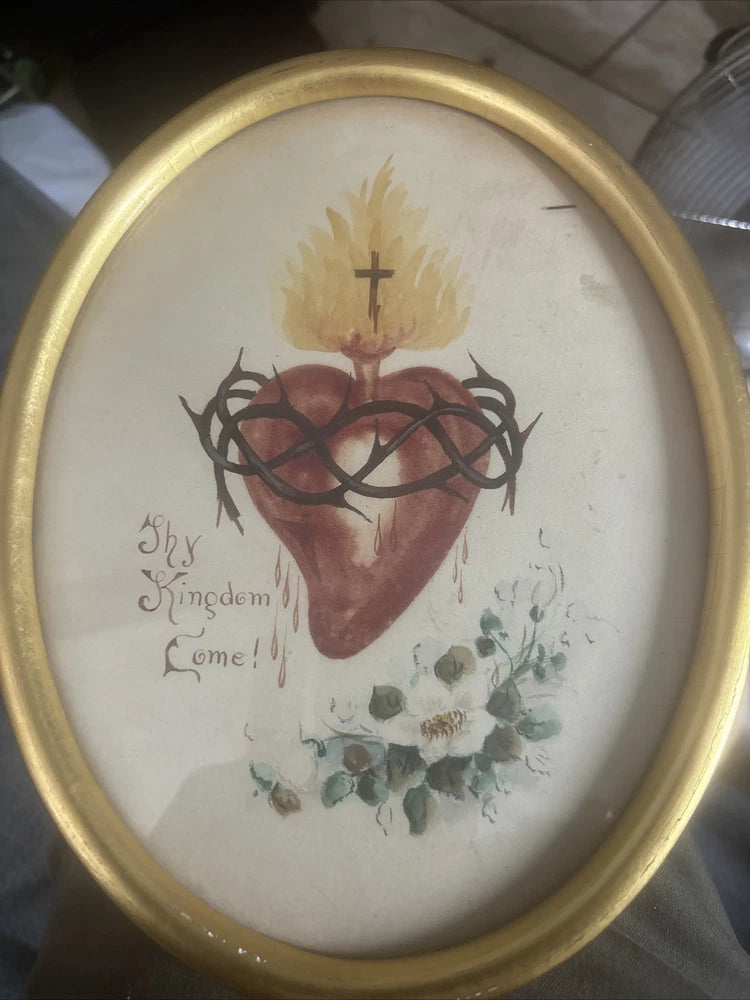 Oval framed vintage print with sacred heart, cross, and dried-flower botanical illustration