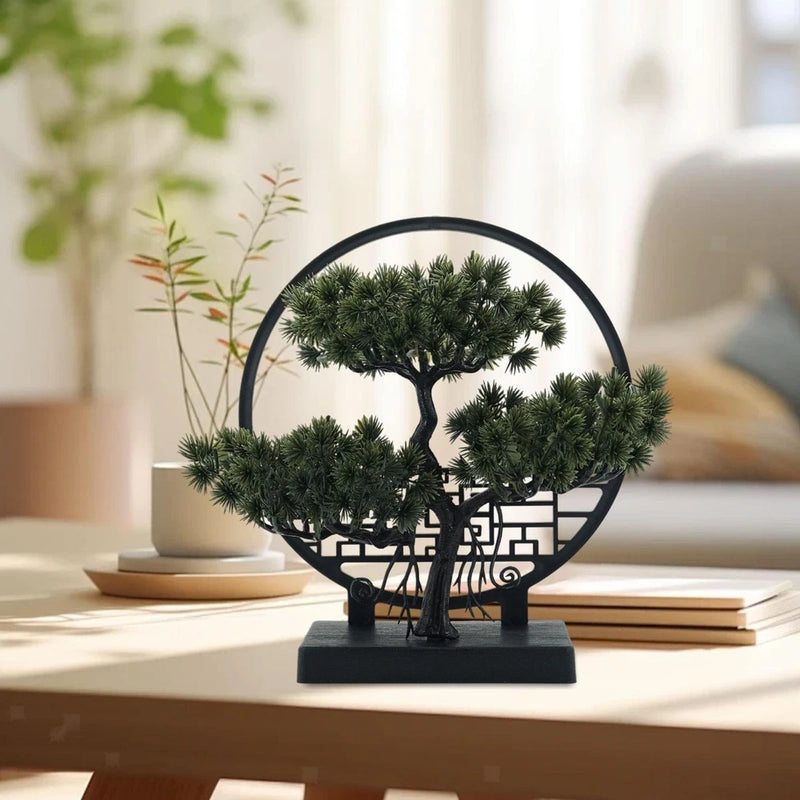 Small artificial bonsai tree ornament with green foliage in black circular stand