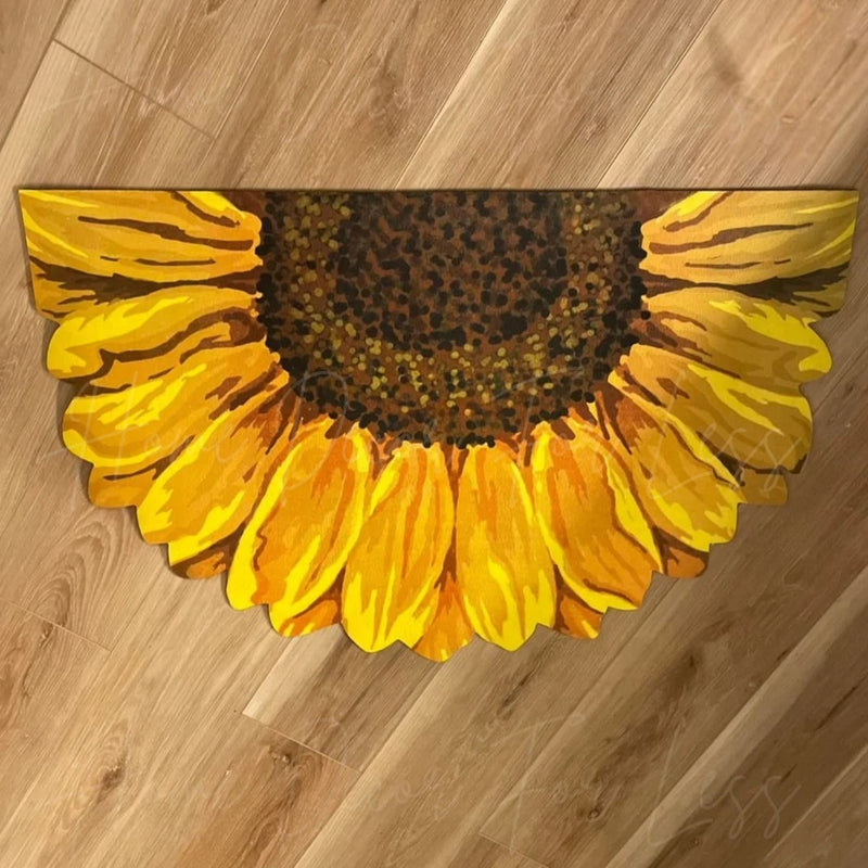 Yellow sunflower shaped half-round door mat with dark center and petal stripes