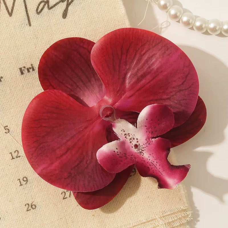 Artificial red orchid flower with pink center, speckled petals for wedding decor