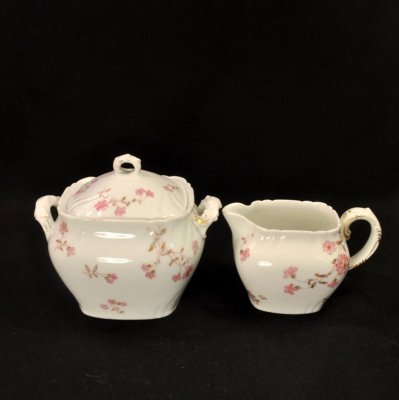 White porcelain creamer and lidded sugar bowl set with pink floral pattern