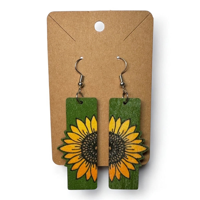 Green wooden sunflower dangle drop earrings with yellow and black floral design