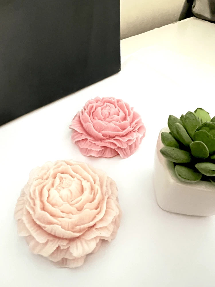 Peony flower soy candle set with two pink peony-shaped candles and green leaf accents
