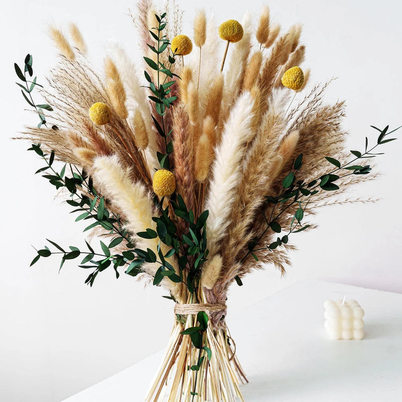 Boho dried bouquet with pampas grass, yellow-brown blooms, green leaves bundle