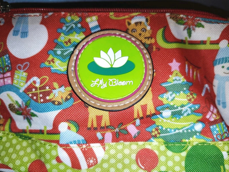 Red snowman wristlet cosmetic case with zipper and round Lilly Bloom logo patch