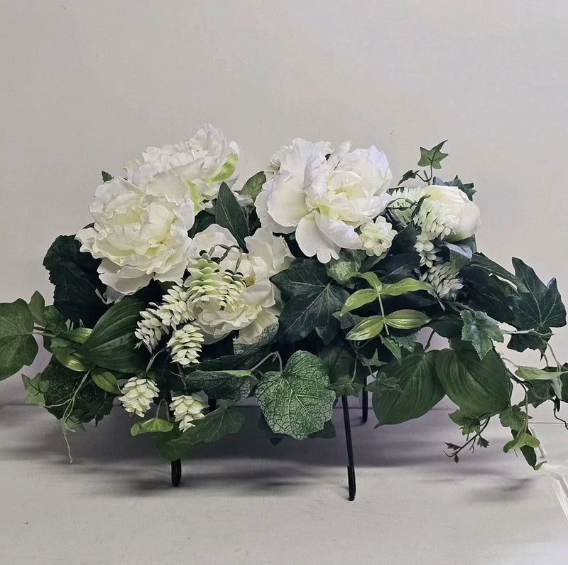 Artificial peony and greenery arrangement on black metal stand, white blooms with green leaves