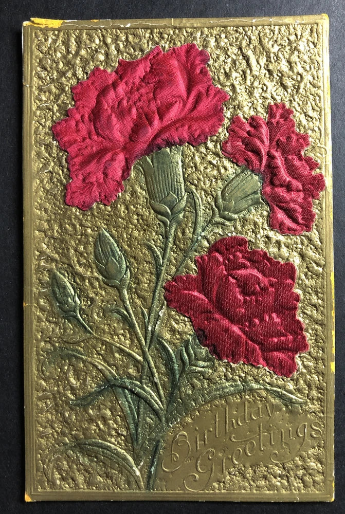 Embossed greeting card with red fabric carnation blooms, green leaves, raised text